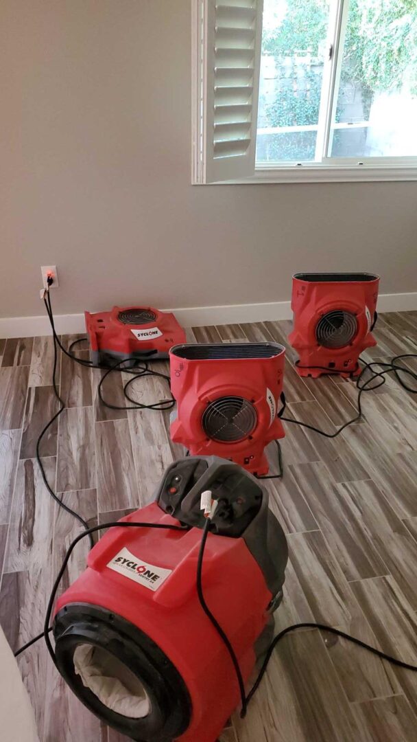 Air movers drying a water-damaged floor in a Las Vegas home