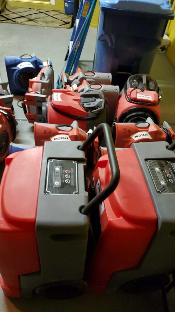 Air movers and dehumidifiers staged and ready for a water damage job