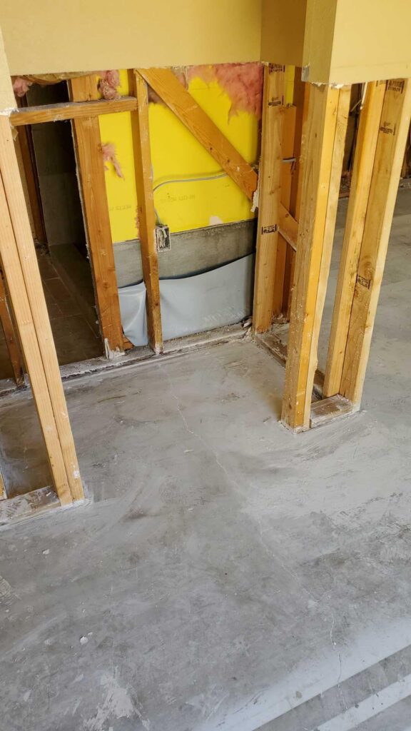 Wall opened to the framing after wet drywall was removed